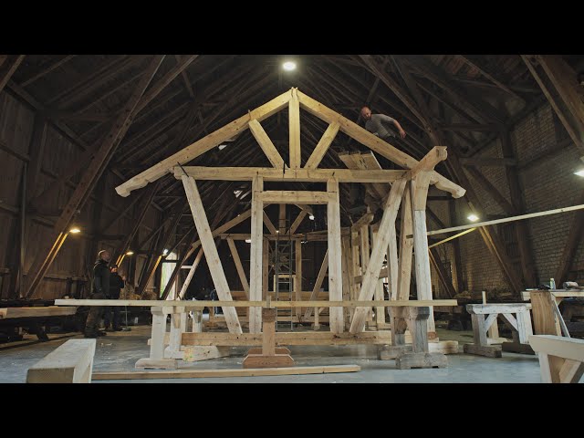 Northmen guild's carpentry class. Raising hand hewn timber frame cabin.