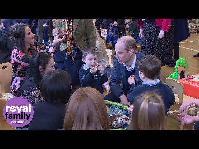 Duke of Cambridge and children play with dinosaurs