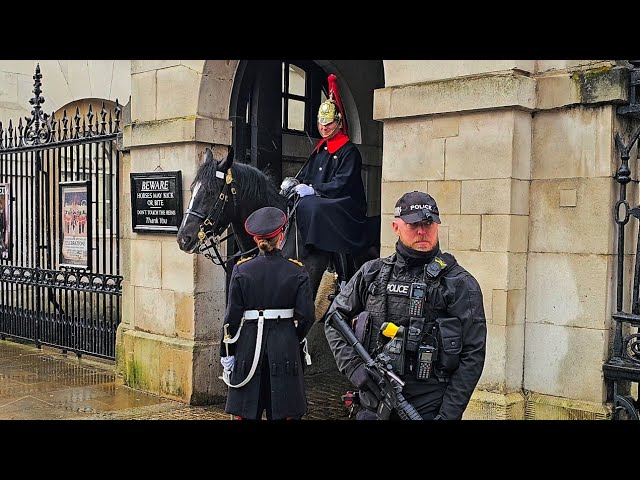 POLICE SHOUT and GUARDS and HORSES get soaked on a soggy Saturday at Horse Guards!