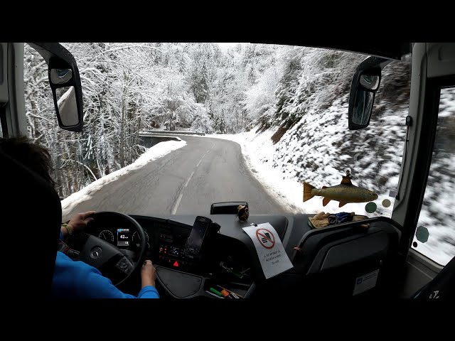 Early bus drive to snowy mountain in the Alps