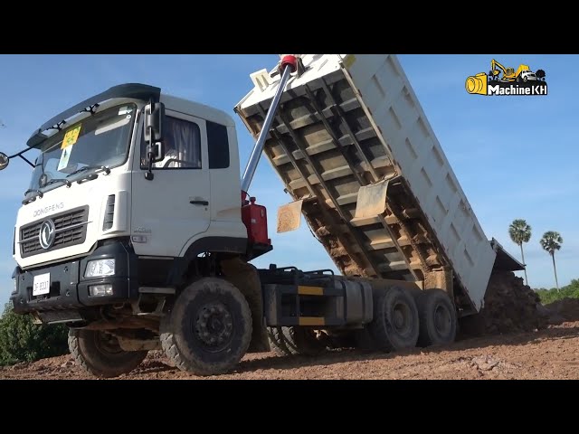 Dump trucks operator with Komatsu Bulldozer pushing landscape | Machine Kh