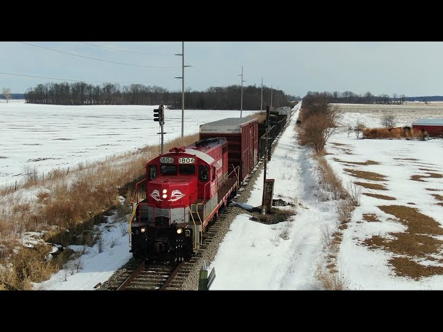 RJ Corman RJC 1806 leaves Lima and some NS trains in the snow