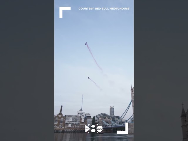Skydivers glide through London’s Tower Bridge