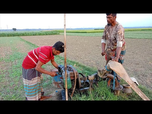 A skill farmer and a boy try to lifting water by 5hp diesel engine. 5hp water pump start process.