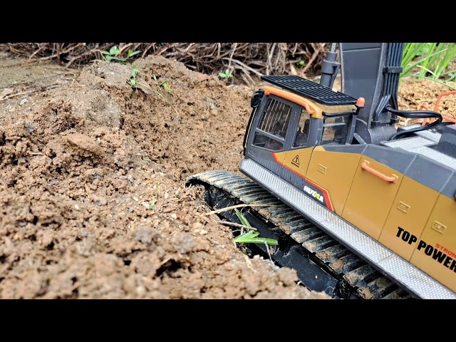 Excavator digs canals in onion fields