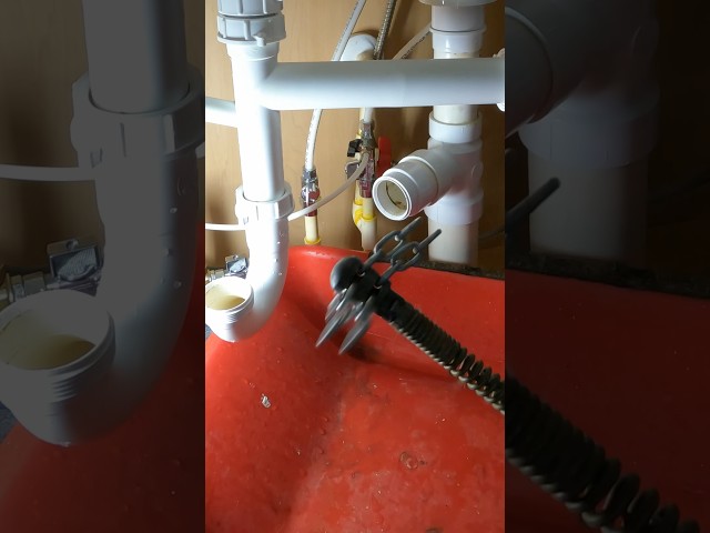 Snaking a kitchen sink drain blockage 💦 #plumbing  #plumber #shortscreator