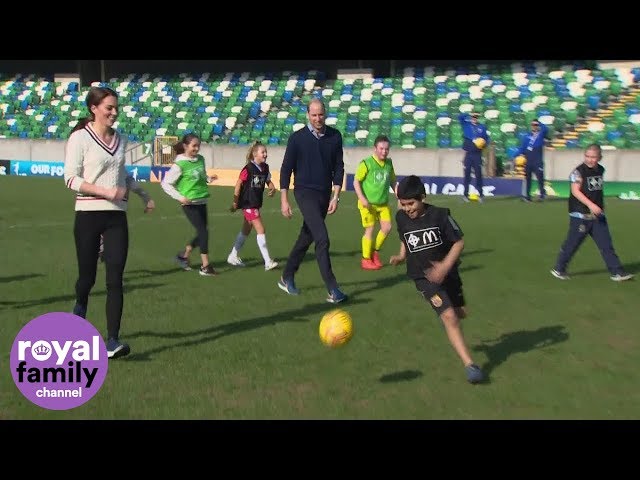 The Duke and Duchess of Cambridge join children on the pitch at Windsor Park, Belfast