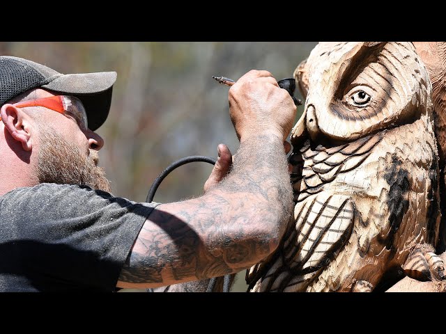 Chainsaw sculptor Josh Landry works his latest piece in Old Lyme