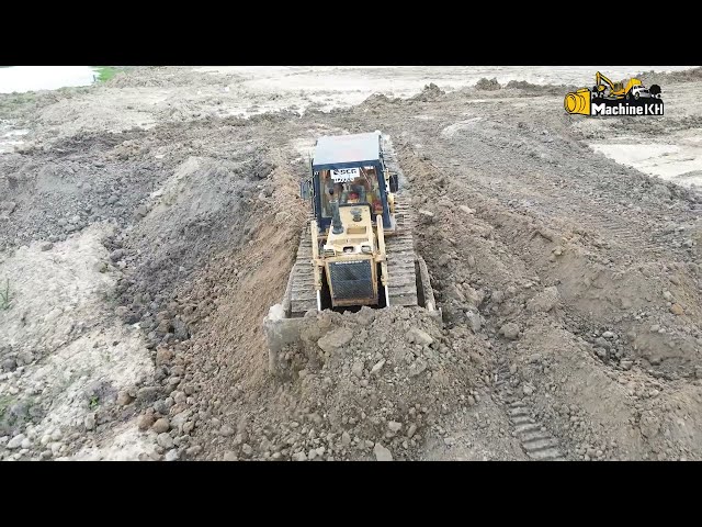 Komatsu Bulldozer pushing rock and sand filling up into water to be  landscape | Machine Kh
