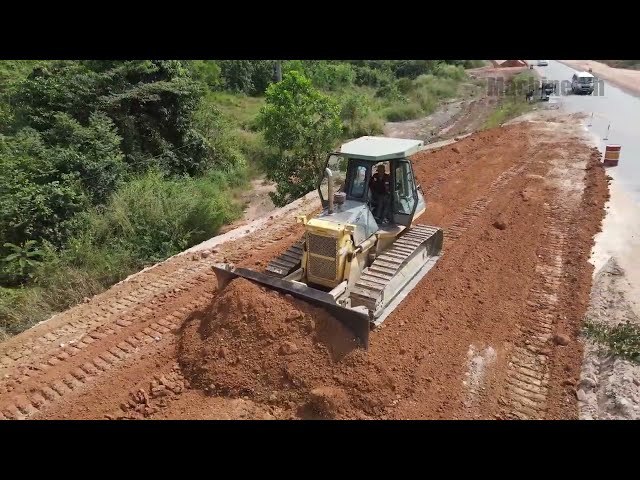Amazing perfect Bulldozer showing skillfully pushing rock to constructed road on the mountain