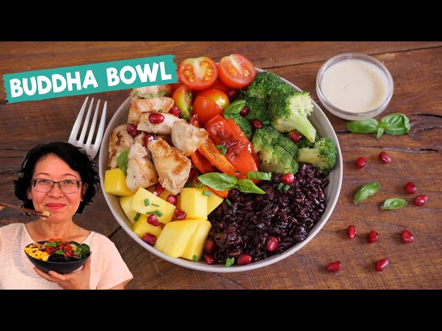 Buddha Bowl with Grilled Chicken + Black Rice. Healthy food with broccoli, mango, tomatoes...
