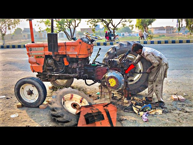 Talented Mechanic Repair Back Wheel of Farming Tractor on Road Side....