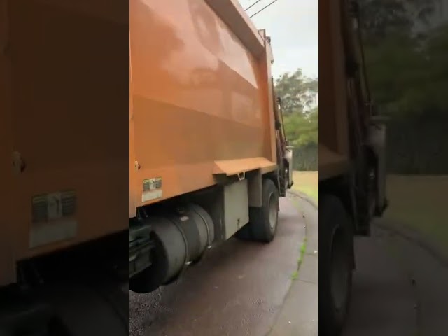 An orange garbage truck Maitland garbo 10 video