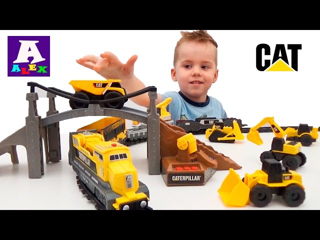 Building machines. The train and the bridge and the Caterpillar construction equipment