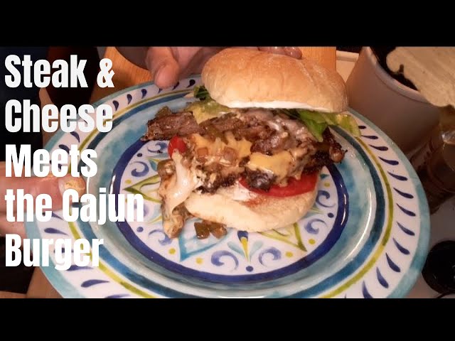 Steak & Cheese meets the Cajun Burger! Sliced NY Strip Steak peppers onions cheese on a Cajun burger