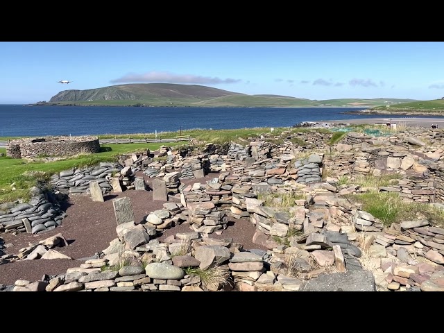 Plane landing at Sumburgh Airport, Shetland Islands, over Scatness Broch & Iron Age Village site