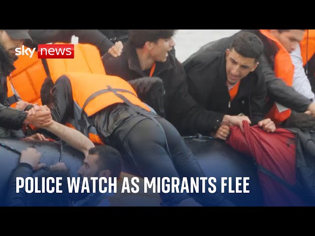 French police watch on as migrants attempt to board small boat to Britain