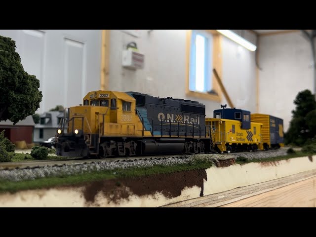 Custom HO scale Ontario Northland 2202 leads a work train