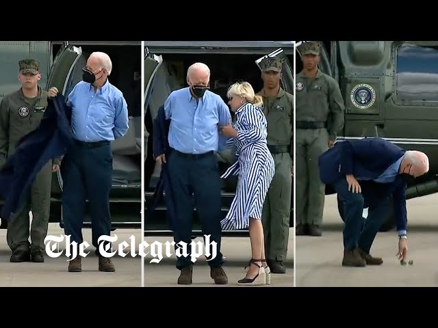 Joe Biden struggles to get his jacket on before dropping his sunglasses
