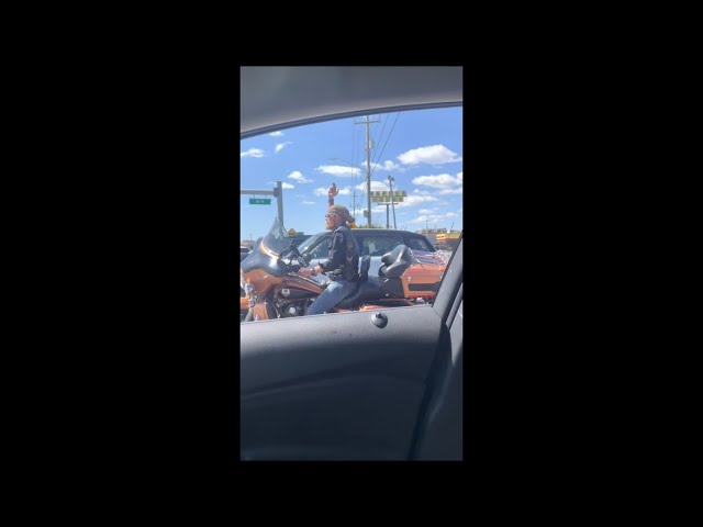 Guy on a Touring Motorcycle Dancing to Gangnam Style at a Traffic Light Stop
