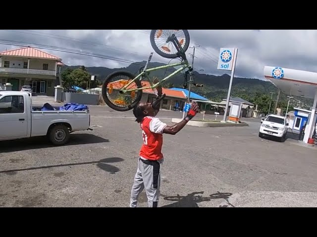 Holding a bmx up with his mouth | 1400 BIKERS St. Lucia