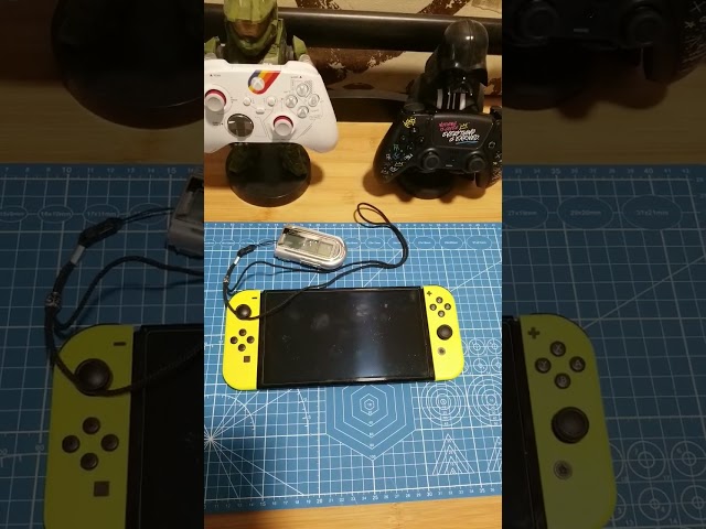 How much bigger is the Switch OLED compared to the Creative Labs Rhomba?