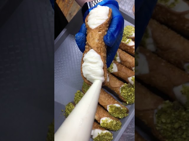 Filling a real Cannoli with a creamy ricotta