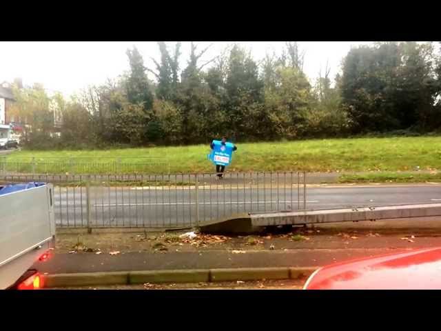 Dominos pizza ad man dancing at the roadside.