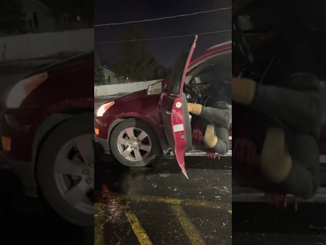 Woman struggles to get into her car because she's slipping on black ice...