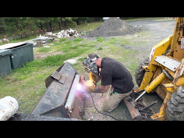 Mobile welding skid steer repair