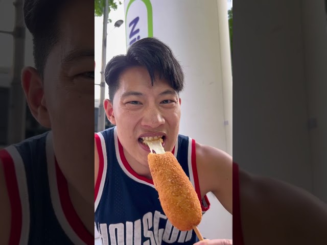 Eating a super cheesy corn dog at the convenience store in Korea