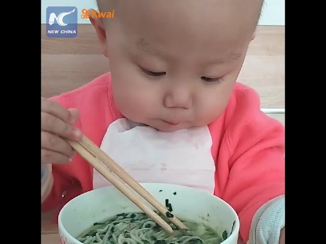 Adorable: Two-year-old baby using chopsticks like a pro
