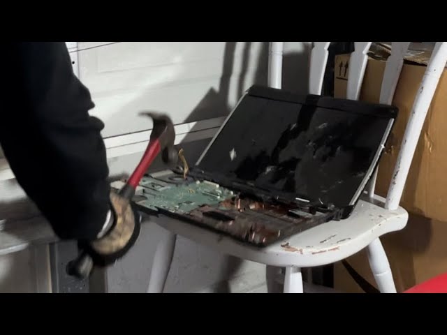 Angry office worker smashes Compaq laptop