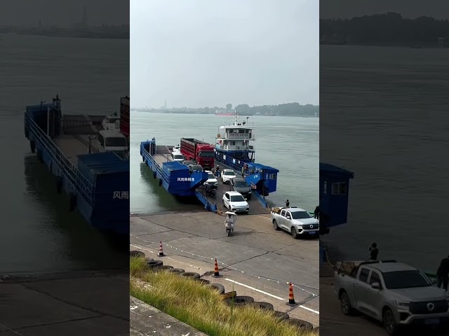 Truck driver boarding a boat to cross the river. Ferry crossing the river. Car ferry crossing th