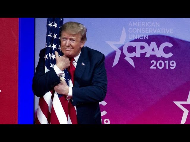 President Donald Trump hugged the flag on the stage at the CPAC