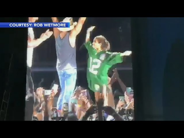 Philadelphia Eagles quarterback Carson Wentz brings young fan onto stage at Kenny Chesney concert