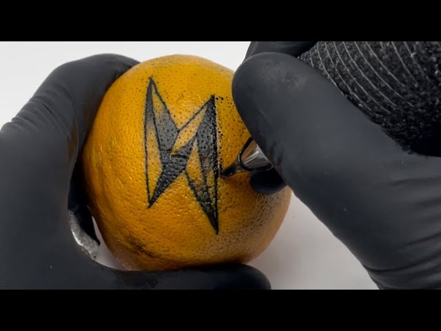 Tattooing “thunderbolt” on a orange