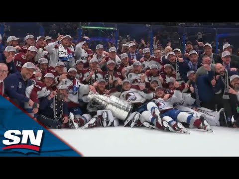 Colorado Avalanche Gather Around Centre Ice To Pose For A Photo With The Stanley Cup