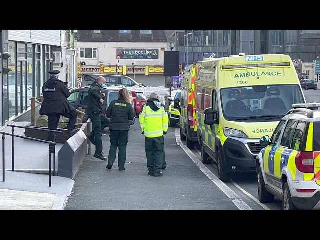 Man led out of asylum seeker hotel in Newquay, Cornwall by emergency service worker in hazmat suit