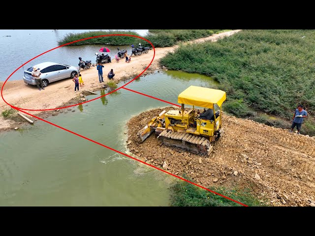 Whole video!! It is impressive that the KOMATSU Dozer crew can even pour stone to create water road