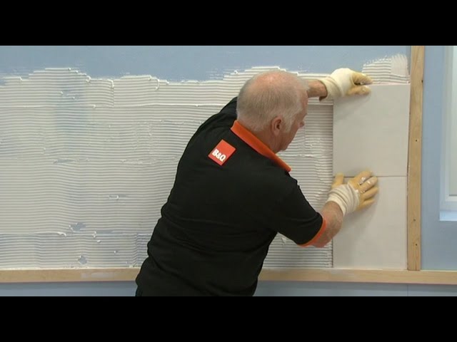 How to Tile a Wall Apply First Batch of Tile and Apply a layer of adhesive to the wall