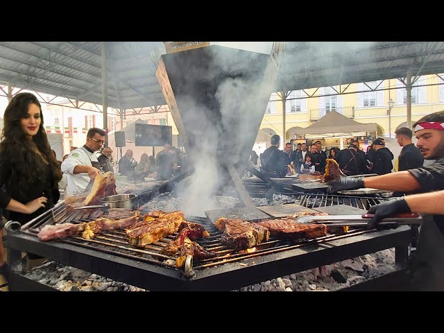 Italy Street Food Fairs. Huge Hexagonal Grill of Giants 'Fiorentina' Steak, Pork, Ribs & more