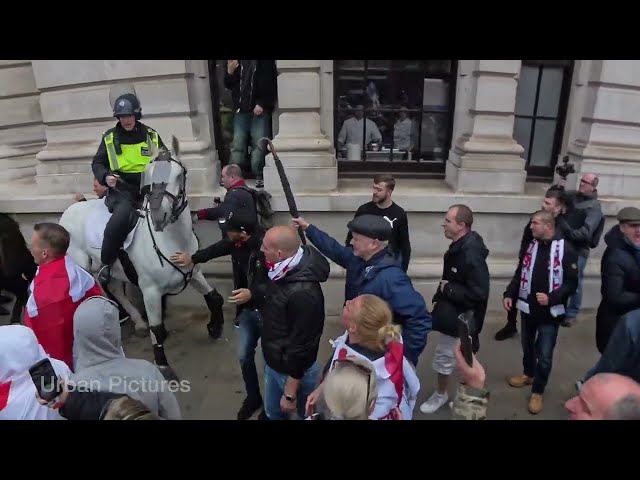 The moment a man swings an umbrella at a police horse during St George’s Day celebrations in London