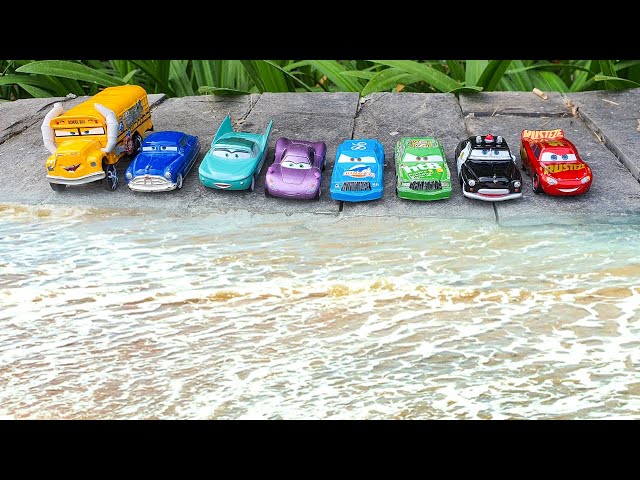 Disney Pixar Cars fall into the water: Lightning McQueen, Sally Carrera, Mack Trucks, Jackson Storm