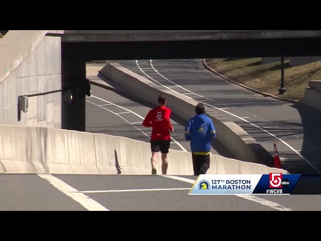 Running the final stretch of the Boston Marathon with race director