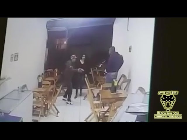 Armed Victim Waits For His Turn Against Armed Robbers