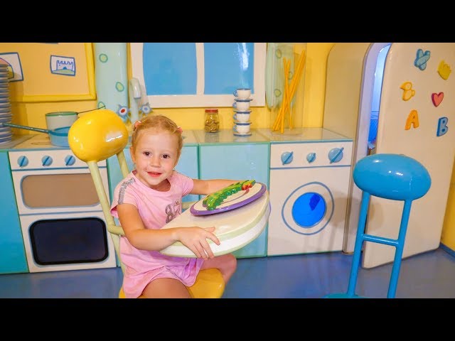 Nastya plays at the funny playhouse of Peppa toy Theme Park