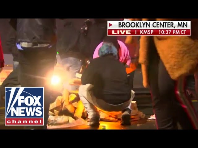 Protesters appear to light debris on fire in Brooklyn Center