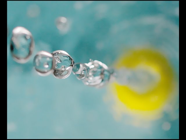 Slow Motion tennis ball drop into water