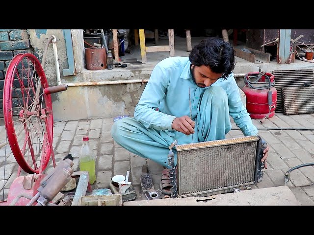 This young mechanic is brilliant in radiator repairing